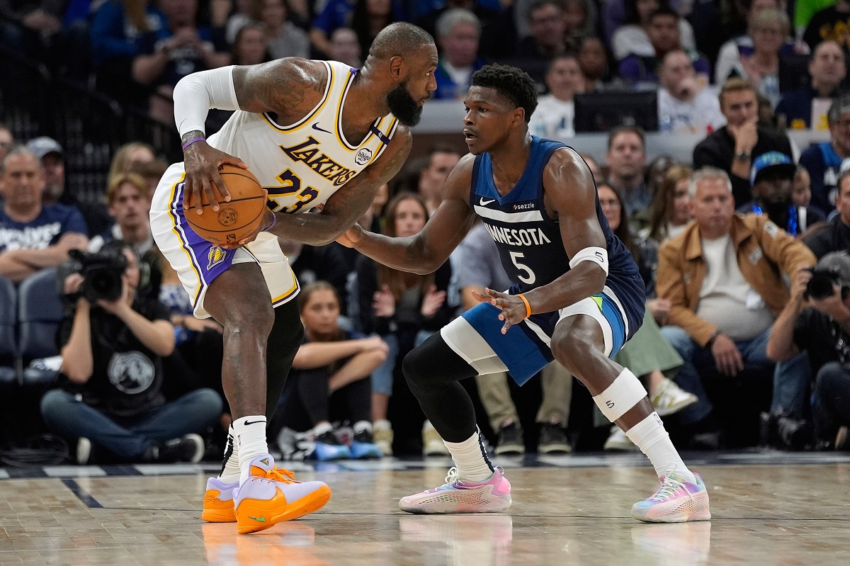 Los Angeles Lakers forward LeBron James (23) handles the ball as Minnesota Timberwolves guard Anthony Edwards (5) defends during the first half of Game 4 of an NBA basketball first-round playoff series, Sunday, April 27, 2025, in Minneapolis. (AP Photo/Abbie Parr)