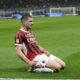AC Milan's Luka Jovic, front, celebrates after scoring during the Italian Cup semifinal second leg soccer match between Inter Milan and AC Milan at the San Siro stadium in Milan, Italy, Wednesday, April 23, 2025. (AP Photo/Luca Bruno)