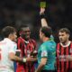 Referee Giovanni Ayroldi shows a yellow card to AC Milan's Rafael Leao during the Italian Serie A soccer match between AC Milan and Fiorentina at the San Siro Stadium in Milan, Italy, Saturday, April 5, 2025. (AP Photo/Antonio Calanni)