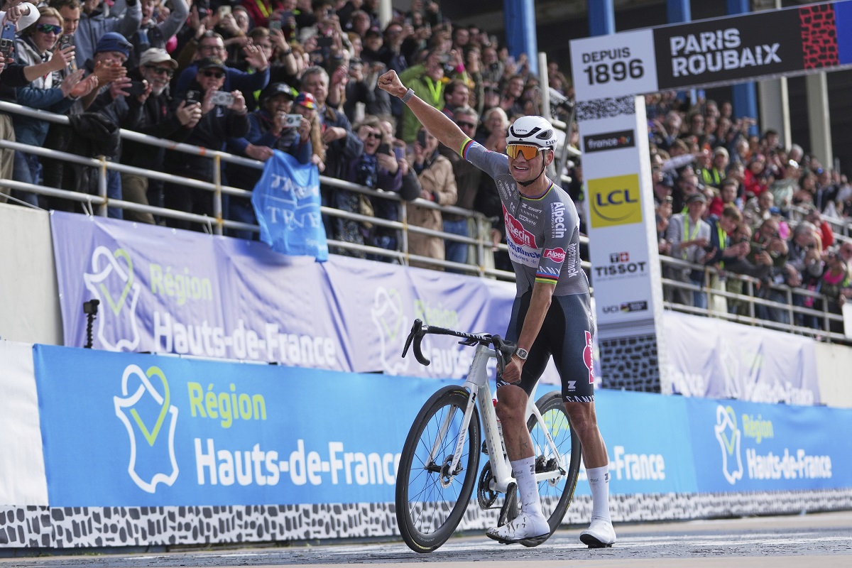 Mathieu van der Poel, of the Netherlands, celebrates as he crosses the finish line to win the Paris-Roubaix cycling race in Roubaix, France, Sunday, April 13, 2025. (AP Photo/Thibault Camus)