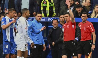 Real Madrid's Kylian Mbappe, 2nd left is shown a red card by the referee during a Spanish La Liga soccer match between Alaves and Real Madrid at the Mendizorroza stadium in Vitoria, Spain, Sunday April 13, 2025. (AP Photo/Miguel Oses)