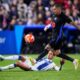 Barcelona's Raphinha, right, and Leganes' Sergio Gonzalez challenge for the ball during the Spanish La Liga soccer match between CD Leganes and Barcelona at the Butarque stadium in Leganes, outside Madrid, Spain, Saturday, April 12, 2025. (AP Photo/Manu Fernandez)