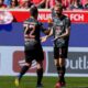 Bayern's Raphael Guerreiro, left, and Bayern's Konrad Laimer celebrate after a goal during the German Bundesliga soccer match between Heidenheim and Bayern Munich in Heidenheim, Germany, Saturday, April 19, 2025. (AP Photo/Matthias Schrader)