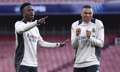 Real Madrid's Vinicius Junior and Kylian Mbappe react, during a training session at the Emirates Stadium, in London, Monday April 7, 2025, a day ahead of the 1st leg Champions League soccer match against Arsenal on Tuesday. (Bradley Collyer/PA via AP)