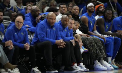 Milwaukee Bucks' Giannis Antetokounmpo and Damian Lillard watch from the bench during the first half of an NBA basketball game against the Detroit Pistons, Sunday, April 13, 2025, in Milwaukee. (AP Photo/Aaron Gash)