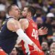 Denver Nuggets center Nikola Jokic, left, moves past Los Angeles Clippers center Ivica Zubac in the second half of Game 2 of a first-round NBA playoff series Monday, April 21, 2025, in Denver. (AP Photo/David Zalubowski)