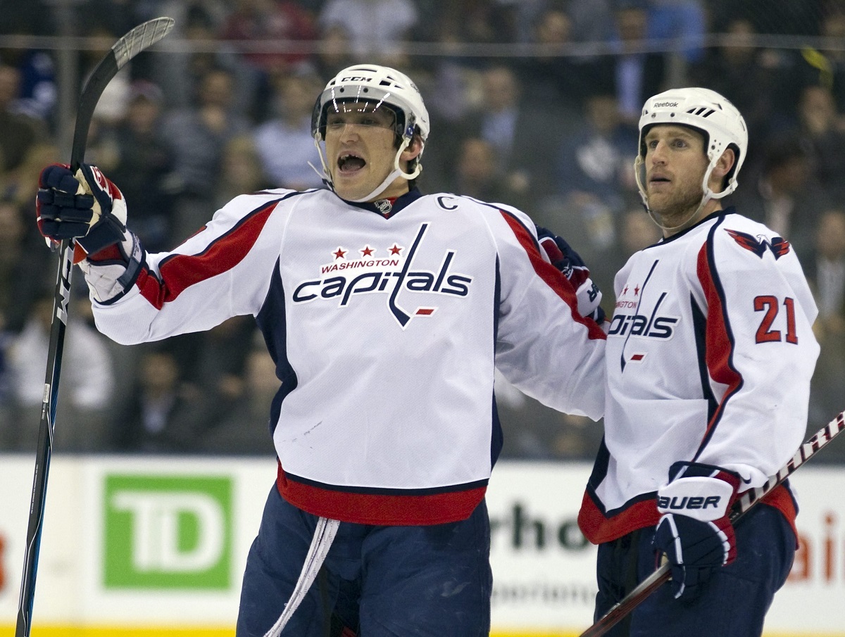 FILE - Washington Capitals Alexander Ovechkin, left, celebrates scoring his 300th NHL career goal with teammate Brooks Laich (21) during first period of an NHL hockey game against the Toronto Maple Leafs, Tuesday, April 5, 2011, in Toronto. (Frank Gunn/The Canadian Press via AP, FIle)