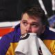 Los Angeles Lakers' Luka Doncic becomes emotional as he watches a video on the large video board that was a tribute to the former Dallas Mavericks player before an NBA basketball game in Dallas, Wednesday, April 9, 2025. (AP Photo/LM Otero)