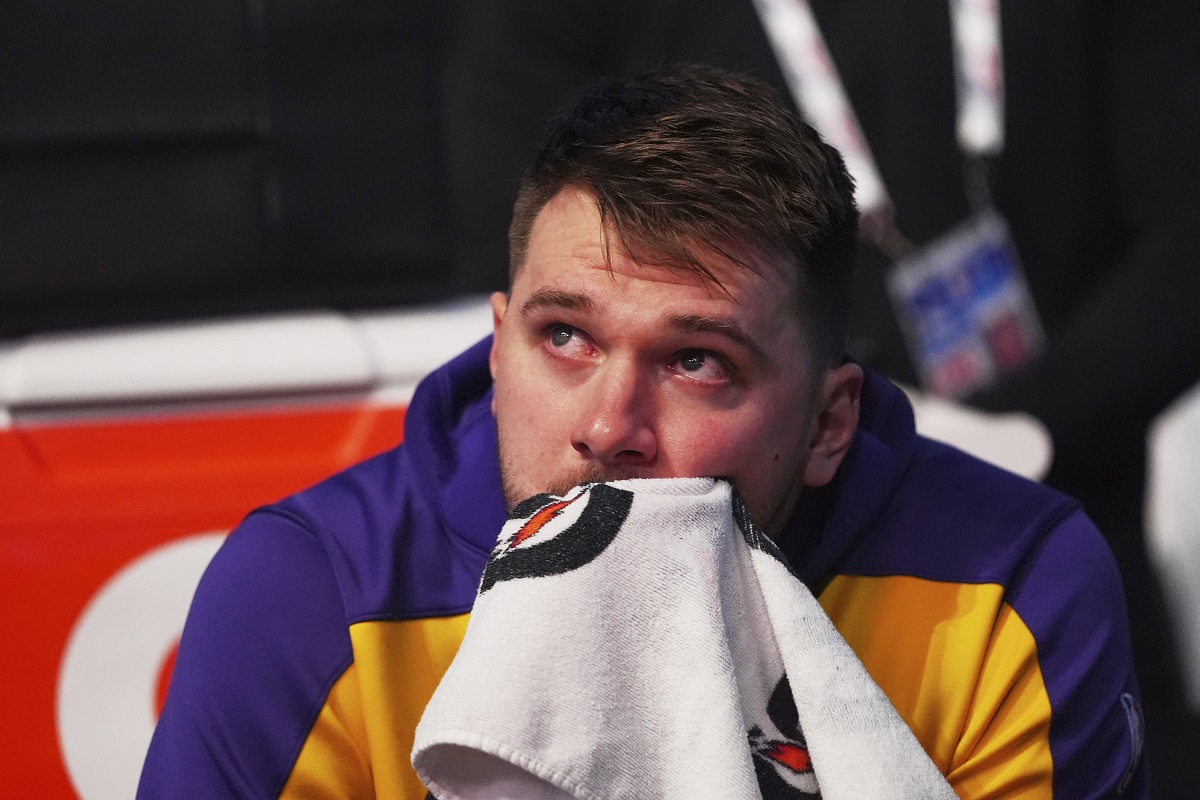 Los Angeles Lakers' Luka Doncic becomes emotional as he watches a video on the large video board that was a tribute to the former Dallas Mavericks player before an NBA basketball game in Dallas, Wednesday, April 9, 2025. (AP Photo/LM Otero)