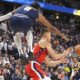 Los Angeles Clippers guard Bogdan Bogdanovic, center, passes the ball as Denver Nuggets forward Peyton Watson, left, defends in the second half of Game 2 of a first-round NBA playoff series Monday, April 21, 2025, in Denver. (AP Photo/David Zalubowski)