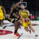 Fenerbahce's Marko Guduric, right, goes past Monaco's Jaron Blossomgame during the Euroleague final basketball match between Monaco and Fenerbahce in Abu Dhabi, United Arab Emirates, Sunday, May 25, 2025. (AP Photo/Altaf Qadri)