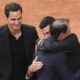 Rafa Nadal, second right, is hugged by Novak Djokovic as Roger Federer, left, look at them, during a farewell ceremony at center court Philippe-Chatrier, at the Roland-Garros stadium, in Paris, Sunday May 25, 2025. (AP Photo/Christophe Ena)