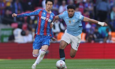 Crystal Palace's Daichi Kamada, left, and Manchester City's Omar Marmoush fight for the ball during the FA Cup final between Manchester City and Crystal Palace at the Wembley Stadium in London, Saturday, May 17, 2025. (AP Photo/Ian Walton)