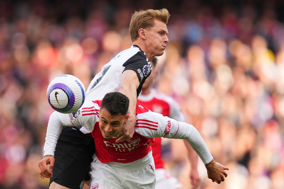 Newcastle's Emil Krafth challenges for the ball with Arsenal's Gabriel Martinelli, bottom, during the English Premier League soccer match between Arsenal and Newcastle United at Emirates stadium in London, Sunday, May 18, 2025. (AP Photo/Kirsty Wigglesworth)