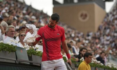 Serbia's Novak Djokovic holds a towel as he plays France's Corentin Moutet during their second round match of the French Tennis Open, at the Roland-Garros stadium, in Paris, Thursday, May 29, 2025. (AP Photo/Christophe Ena)