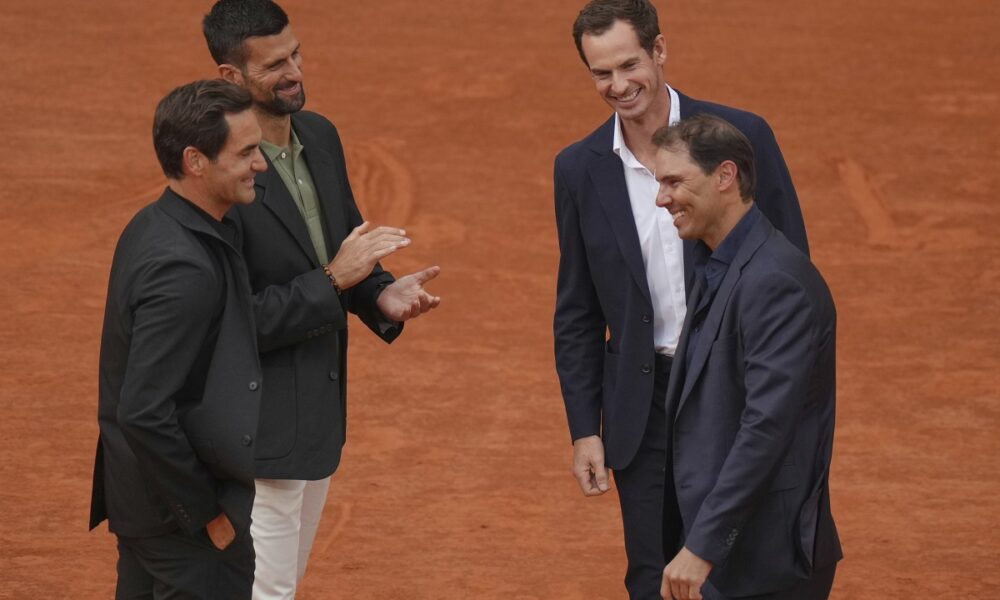 Rafa Nadal, right, is congratulated by Andy Murray, top right, as Roger Federer, left, and Novak Djokovic, during a farewell ceremony at center court Philippe-Chatrier, at the Roland-Garros stadium, in Paris, Sunday May 25, 2025. (AP Photo/Thibault Camus)