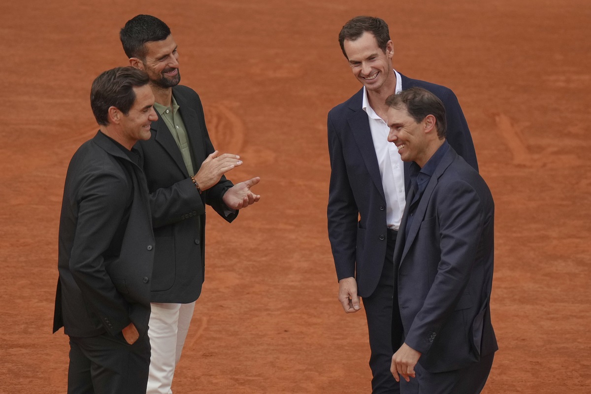 Rafa Nadal, right, is congratulated by Andy Murray, top right, as Roger Federer, left, and Novak Djokovic, during a farewell ceremony at center court Philippe-Chatrier, at the Roland-Garros stadium, in Paris, Sunday May 25, 2025. (AP Photo/Thibault Camus)