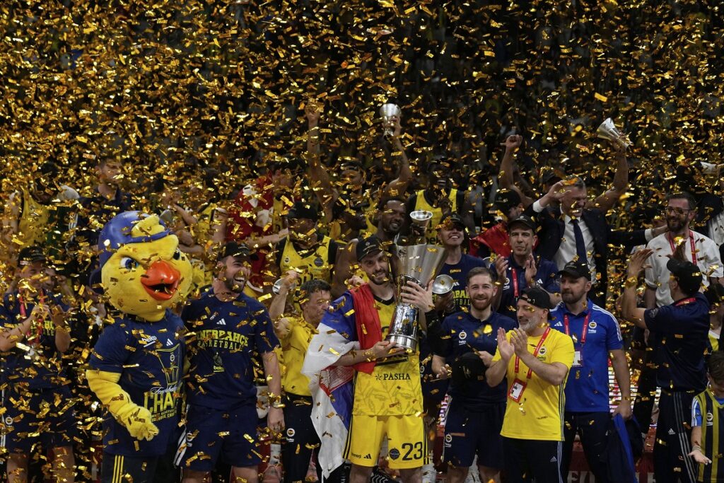 Fenerbahce's Marko Guduric holds the trophy as they celebrate winning the Euroleague final basketball match between Monaco and Fenerbahce in Abu Dhabi, United Arab Emirates, Sunday, May 25, 2025. (AP Photo/Altaf Qadri)