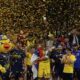 Fenerbahce's Marko Guduric holds the trophy as they celebrate winning the Euroleague final basketball match between Monaco and Fenerbahce in Abu Dhabi, United Arab Emirates, Sunday, May 25, 2025. (AP Photo/Altaf Qadri)