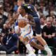 Thunder Nuggets Basketball Oklahoma City Thunder guard Cason Wallace, front, drives past Denver Nuggets center Nikola Jokic, back, in the first half of Game 4 in the Western Conference semifinals of the NBA basketball playoffs Sunday, May 11, 2025, in Denver. (AP Photo/David Zalubowski)