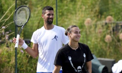 Novak Djokovic of Serbia and Aryna Sabalenka of Belarus attend a practice session at the All England Lawn Tennis and Croquet Club, ahead of the Wimbledon Championships in London, Wednesday, June 25, 2025. (Ben Whitley/PA via AP)