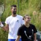 Novak Djokovic of Serbia and Aryna Sabalenka of Belarus attend a practice session at the All England Lawn Tennis and Croquet Club, ahead of the Wimbledon Championships in London, Wednesday, June 25, 2025. (Ben Whitley/PA via AP)