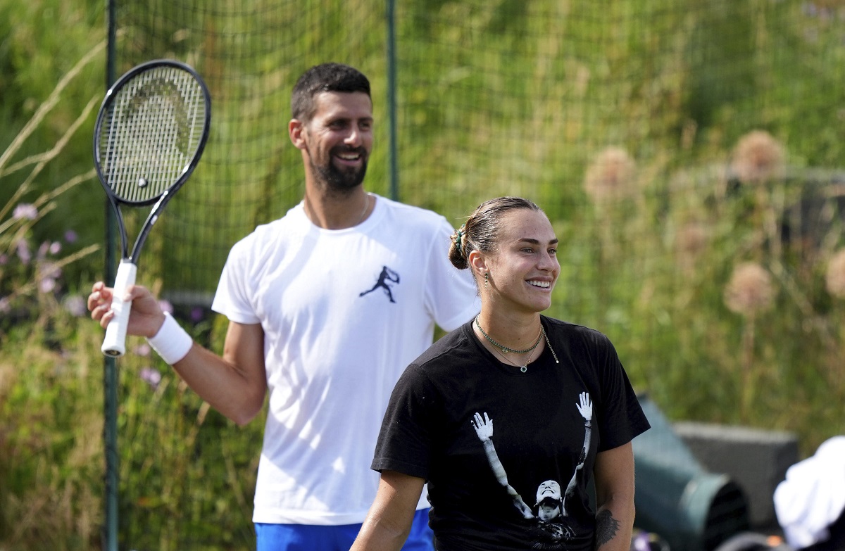Novak Djokovic of Serbia and Aryna Sabalenka of Belarus attend a practice session at the All England Lawn Tennis and Croquet Club, ahead of the Wimbledon Championships in London, Wednesday, June 25, 2025. (Ben Whitley/PA via AP)