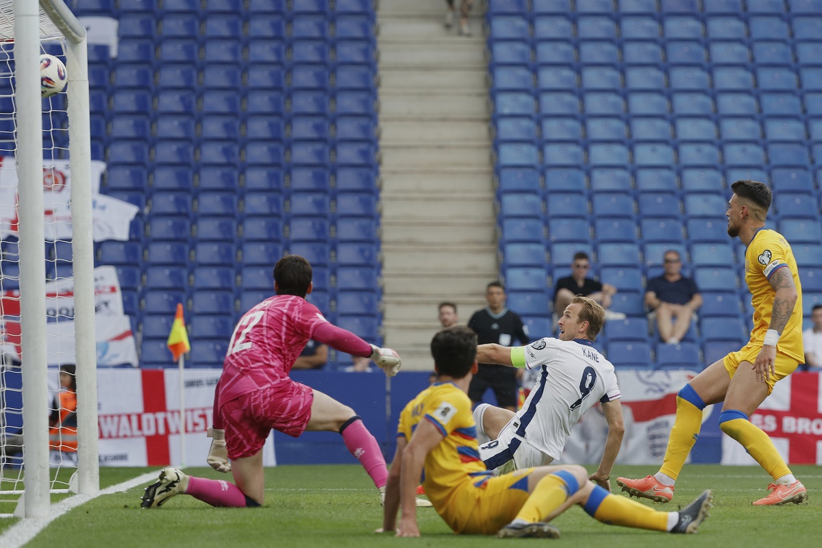 England's Harry Kane, second right, scores the opening goal during a World Cup 2026 group K qualifying soccer match between Andorra and England at the RCDE Stadium in Barcelona, Spain, Saturday, June 7, 2025. (AP Photo/Joan Monfort)