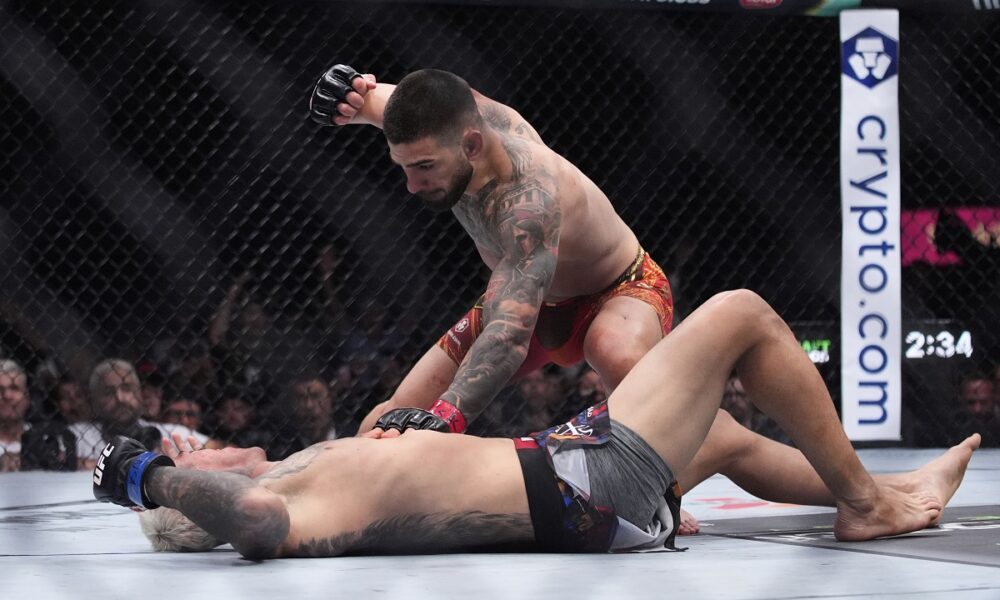 Ilia Topuria pounds on Charles Oliveira in a lightweight title fight at UFC 317, Saturday, June 28, 2025, in Las Vegas. (AP Photo/John Locher)