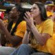 Indian Fever basketball players Caitlin Clark, right, and Aliyah Boston watch during the first half of Game 3 of the NBA Finals basketball series between the Indiana Pacers and the Oklahoma City Thunder, Wednesday, June 11, 2025, in Indianapolis. (AP Photo/Michael Conroy)