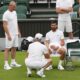 Novak Djokovic of Serbia speaks to a coach during a practice session at the All England Lawn Tennis and Croquet Club, ahead of the Wimbledon Championships in London, Thursday, June 26, 2025. (AP Photo/Kirsty Wigglesworth)