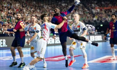 Magdeburg's Antonio Serradilla Cuenca, third left, tries to prevent Barcelona's Rok Ovnicek from taking a shot during the Champions League handball game, semi-final, between FC Barcelona and SC Magdeburg at Lanxess Arena in Cologne, Germany, Saturday June 14, 2025. (Marius Becker/dpa via AP)