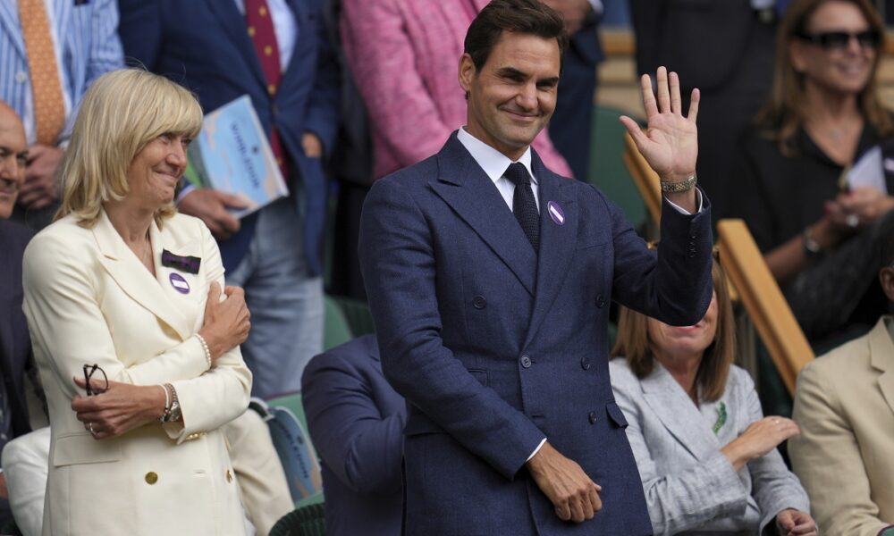 Tennis legend Roger Federer waves after Serbia's Novak Djokovic beat Australia's Alex de Minaur during a fourth round men's singles match at the Wimbledon Tennis Championships in London, Monday, July 7, 2025. (AP Photo/Kin Cheung)