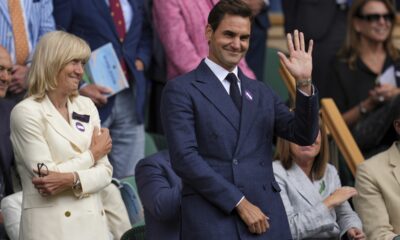 Tennis legend Roger Federer waves after Serbia's Novak Djokovic beat Australia's Alex de Minaur during a fourth round men's singles match at the Wimbledon Tennis Championships in London, Monday, July 7, 2025. (AP Photo/Kin Cheung)