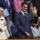 Tennis legend Roger Federer waves after Serbia's Novak Djokovic beat Australia's Alex de Minaur during a fourth round men's singles match at the Wimbledon Tennis Championships in London, Monday, July 7, 2025. (AP Photo/Kin Cheung)