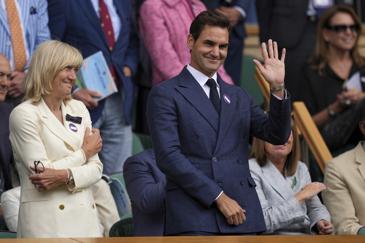 Tennis legend Roger Federer waves after Serbia's Novak Djokovic beat Australia's Alex de Minaur during a fourth round men's singles match at the Wimbledon Tennis Championships in London, Monday, July 7, 2025. (AP Photo/Kin Cheung)