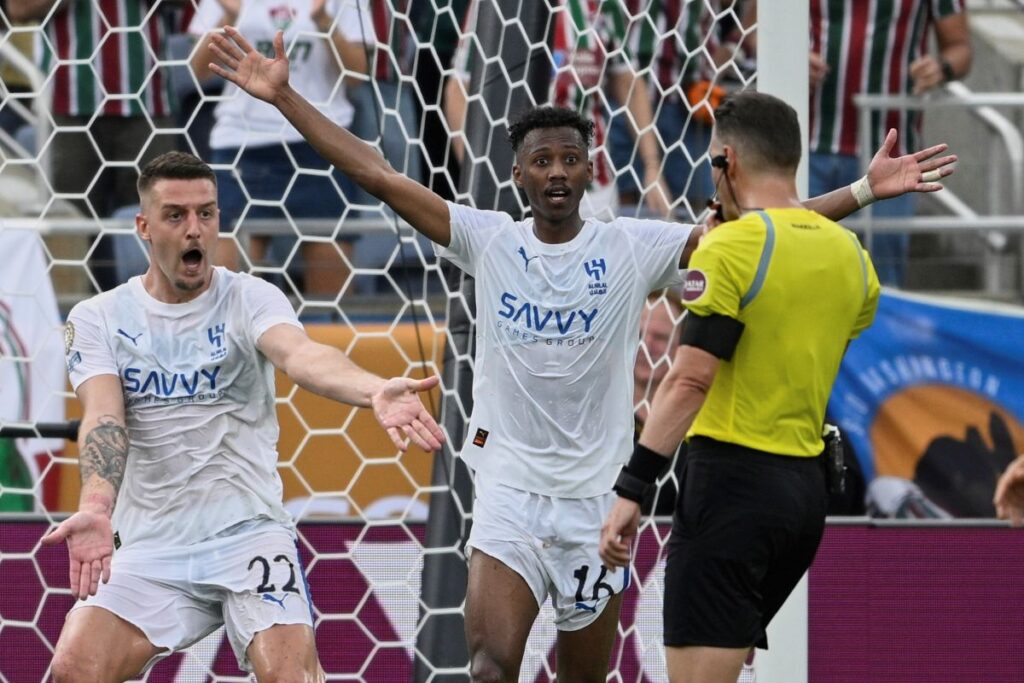 Al Hilal's Sergej Milinkovic-Savic, left, and Al Hilal's Nasser Al-Dawsari complain to the referee during the Club World Cup quarterfinal soccer match between Fluminense and Al Hilal in Orlando, Fla., Friday, July 4, 2025. (AP Photo/Phelan M. Ebenhack)