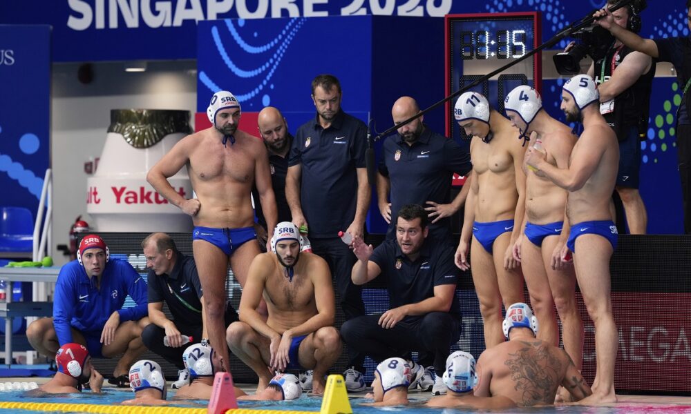 Serbia's head coach Uros Stevanovic speaks to players during a men's water polo semifinal match between Serbia and Hungary at the World Aquatics Championships in Singapore, Tuesday, July 22, 2025. (AP Photo/Vincent Thian)