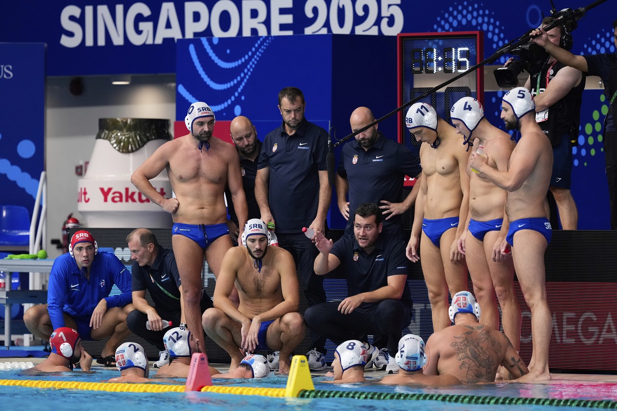 Serbia's head coach Uros Stevanovic speaks to players during a men's water polo semifinal match between Serbia and Hungary at the World Aquatics Championships in Singapore, Tuesday, July 22, 2025. (AP Photo/Vincent Thian)