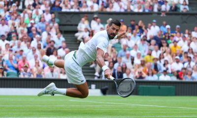 Novak Djokovic of Serbia dives to return to Miomir Kecmanovic of Serbia during a third round men's singles match at the Wimbledon Tennis Championships in London, Saturday, July 5, 2025. (AP Photo/Kirsty Wigglesworth)