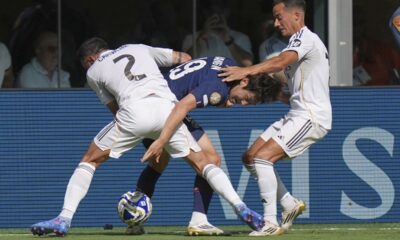 Paris Saint-Germain's Lee Kang-in (19), Real Madrid's Dani Carvajal (2) and Lucas Vazquez (17) battle for the ball during the Club World Cup semifinal soccer match between PSG and Real Madrid in East Rutherford, N.J., Wednesday, July 9, 2025. (AP Photo/Seth Wenig)