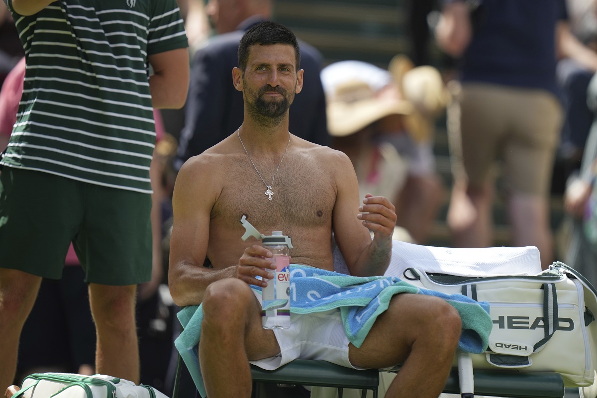 Novak Djokovic of Serbia sits in his chair during a change of ends break as he plays Daniel Evans of Britain during their second round men's singles match at the Wimbledon Tennis Championships in London, Thursday, July 3, 2025. (AP Photo/Alastair Grant)