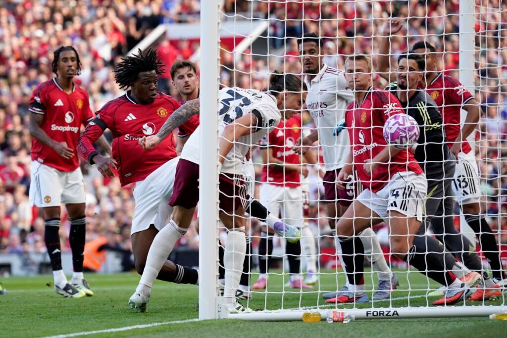 Arsenal's Riccardo Calafiori scores his sides first goal during the English Premier League soccer match between Manchester United and Arsenal at Old Trafford stadium in Manchester, England, Sunday, Aug. 17, 2025. (AP Photo/Dave Thompson)