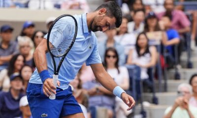 Novak Djokovic, of Serbia, reacts during a mixed doubles match at the U.S. Open tennis championships, Tuesday, Aug. 19, 2025, in New York. (AP Photo/Yuki Iwamura)