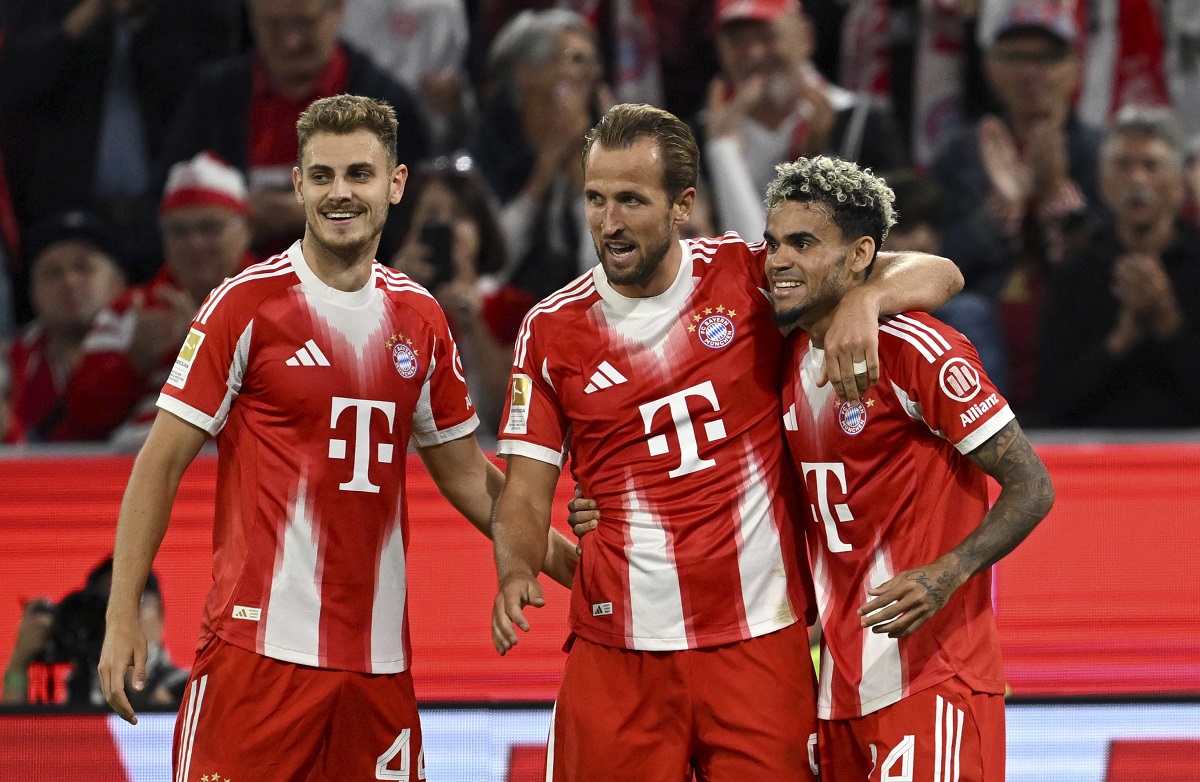 Bayern Munich's Harry Kane, center, celebrates scoring during the Bundesliga soccer match between Bayern Munich and RB Leipzig at Allianz Arena, Munich, Germany, Friday Aug. 22, 2025. (Sven Hoppe/dpa via AP)