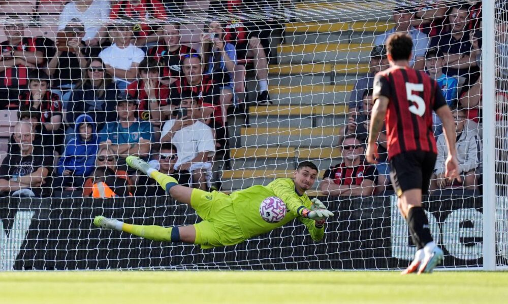 Bournemouth goalkeeper Djordje Petrovic, left, saves Real Sociedad's Mikel Oyarzabal's, not pictured, penalty kick during a pre-season friendly soccer match between Bournemouth and Real Sociedad at Vitality Stadium, Bournemouth, England, Saturday Aug. 9, 2025. (Andrew Matthews/PA via AP)