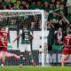 Legia Warsaw's Pawel Wszolek, right, scores his sides second goal against Hibernian during the UEFA Conference League playoff soccer match at Easter Road, Thursday, Aug. 21, 2025, in Edinburgh, Scotland. (Andrew Milligan/PA via AP)