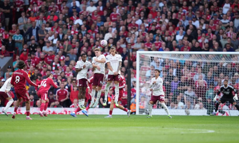 Liverpool's Dominik Szoboszlai, left, shoots to score his sides first goal during the English Premier League soccer match between FC Liverpool and FC Arsenal in Liverpool, England, Sunday, Aug. 31, 2025. (AP Photo/Jon Super)