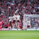 Liverpool's Dominik Szoboszlai, left, shoots to score his sides first goal during the English Premier League soccer match between FC Liverpool and FC Arsenal in Liverpool, England, Sunday, Aug. 31, 2025. (AP Photo/Jon Super)
