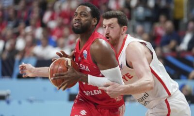Poland's Jordan Loyd, left, and Turkey's Ercan Osmani in action during the Eurobasket, European Basketball Championship quarter final match between Turkey and Poland at the Riga Arena in Riga, Latvia, Tuesday, Sept. 9, 2025. (AP Photo/Sergei Grits)